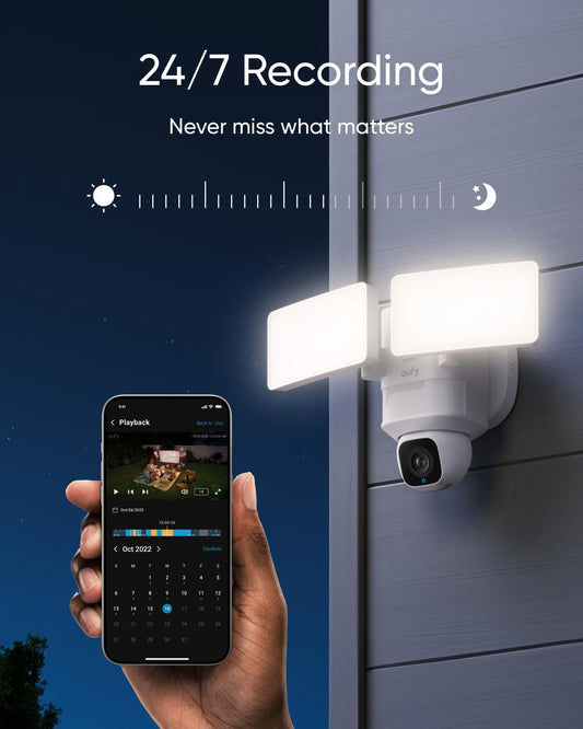 Floodlight security camera in use at night with mobile app showing 24/7 video playback interface
