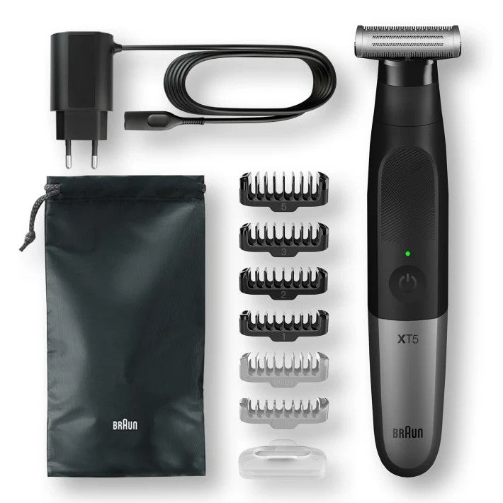 Braun XT5 trimmer set with six comb attachments, travel pouch, charging cable, and protective cap shown laid out